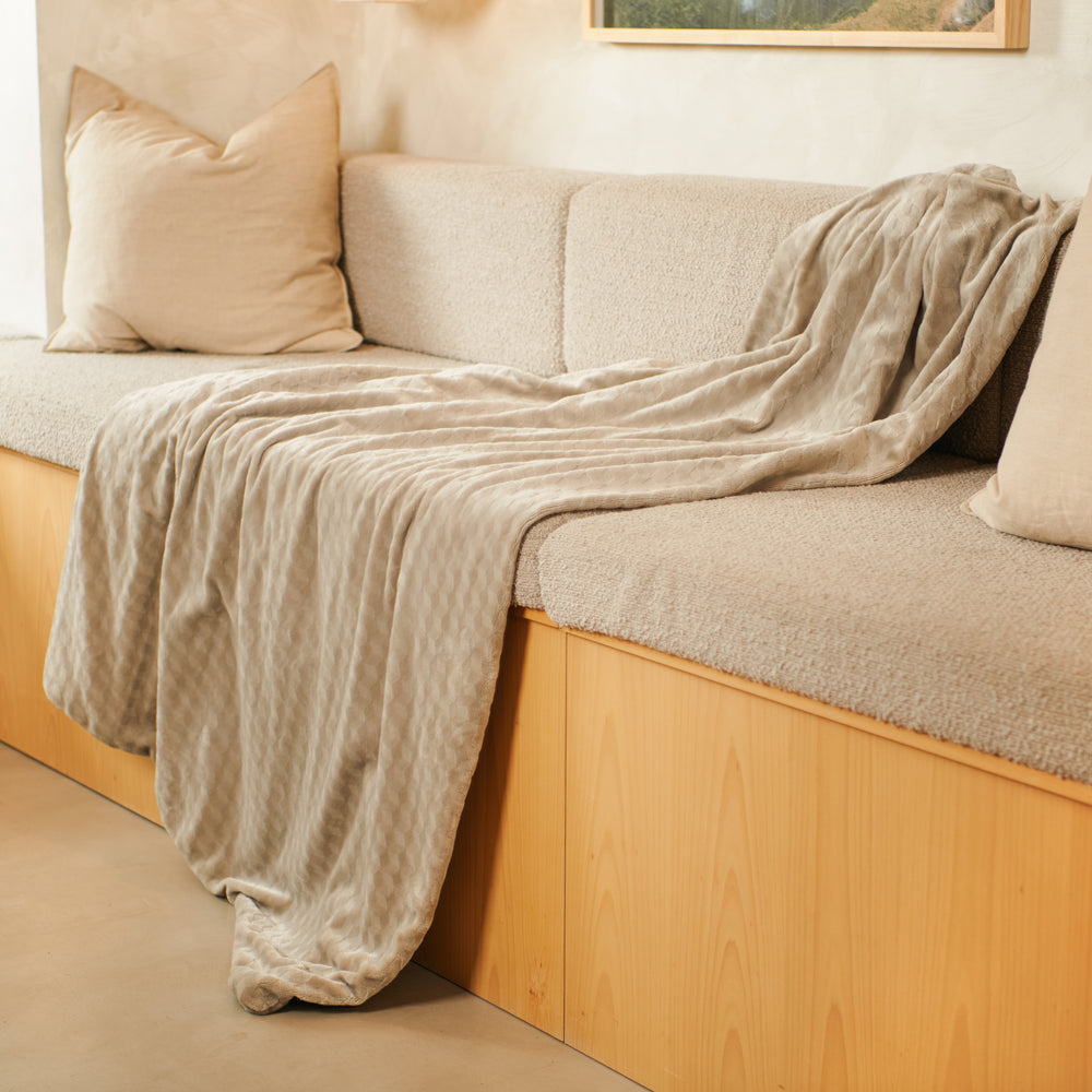 An Indulgent Days Throw draped over a sofa