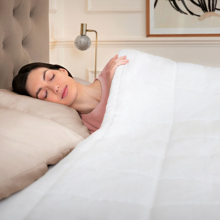 Woman sleeping under a Dreamland heated duvet